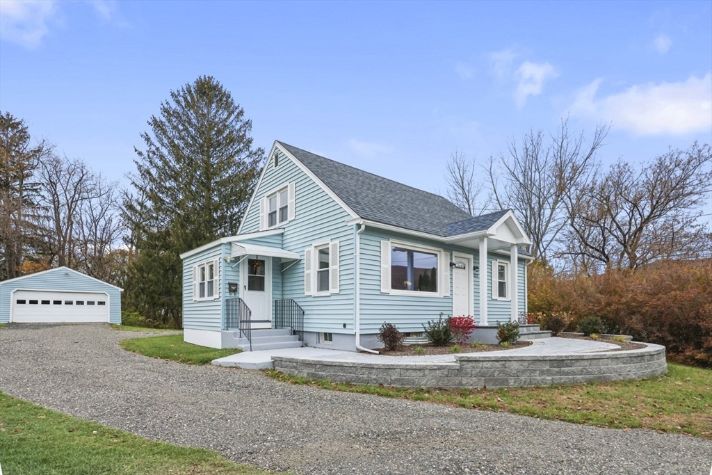 227 Protection North Adams, MA 01247 - Photo 4 of 25 a view of a white house with a small yard and large trees