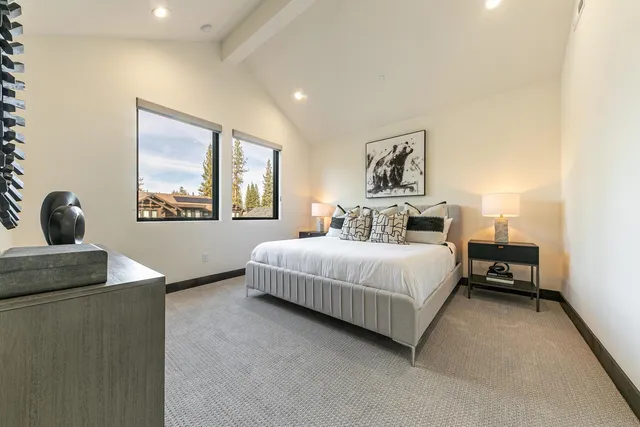 a bathroom with a tub shower sink double vanity and a mirror