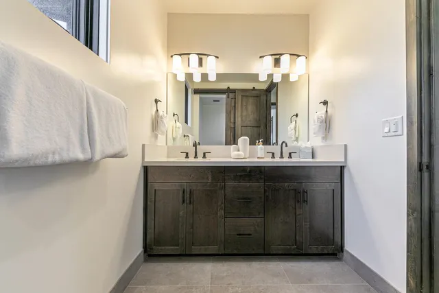 a bathroom with a tub a sink and mirrors