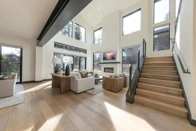 a kitchen with stainless steel appliances kitchen island granite countertop a table chairs sink and cabinets