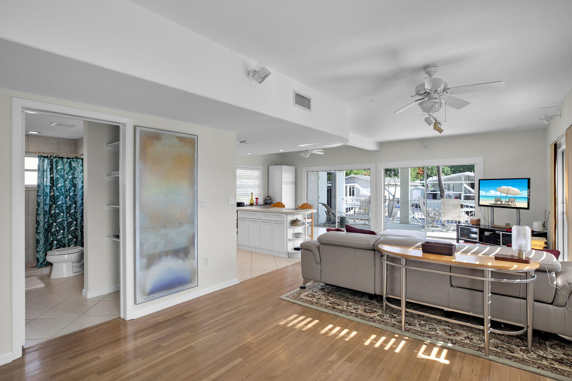 314 Loeb Avenue Key Largo, FL 33037 - Photo 16 of 28 a living room with furniture a chandelier and a wooden floor