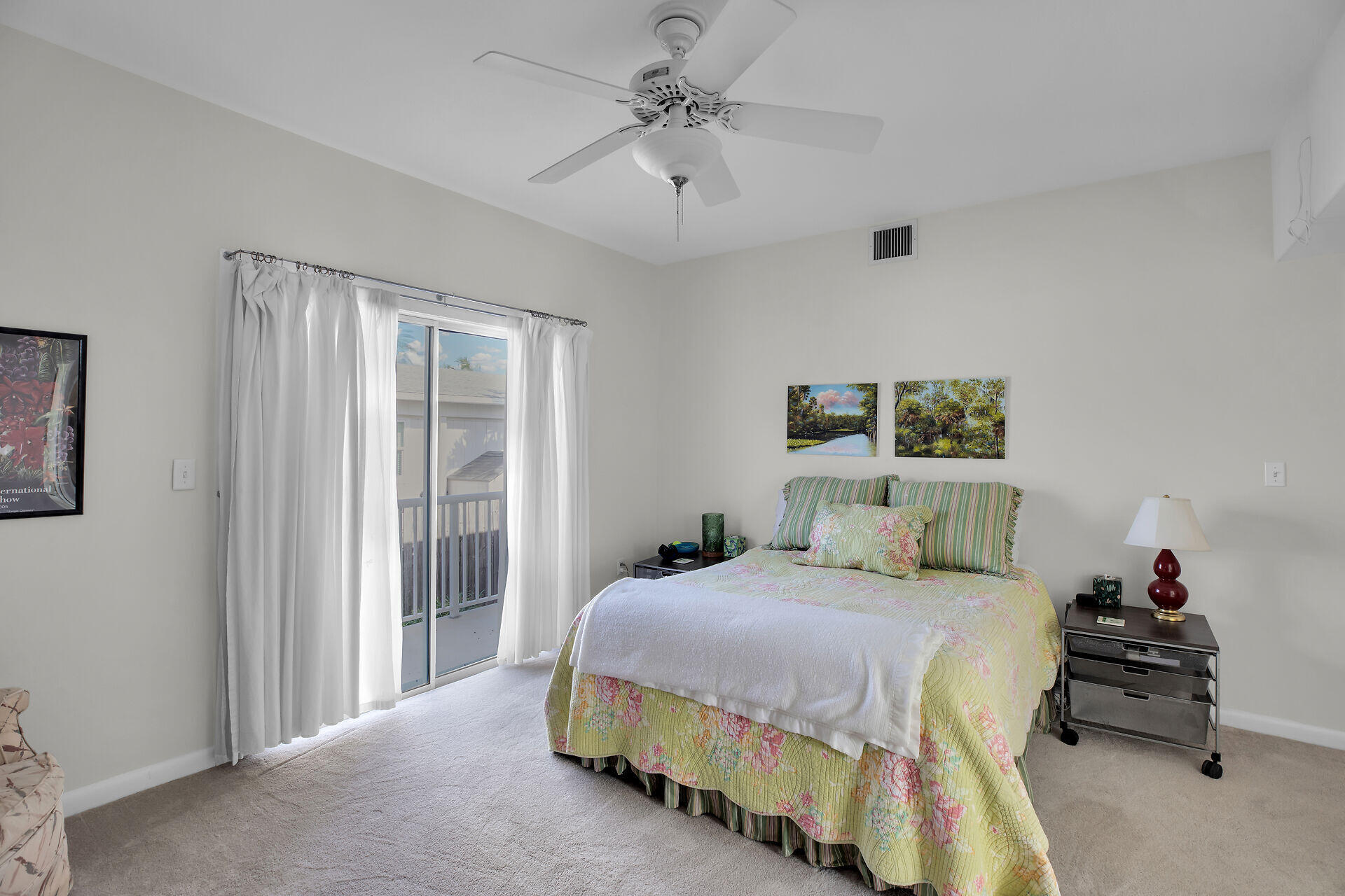 314 Loeb Avenue Key Largo, FL 33037 - Photo 19 of 28 a bedroom with a bed and a chandelier