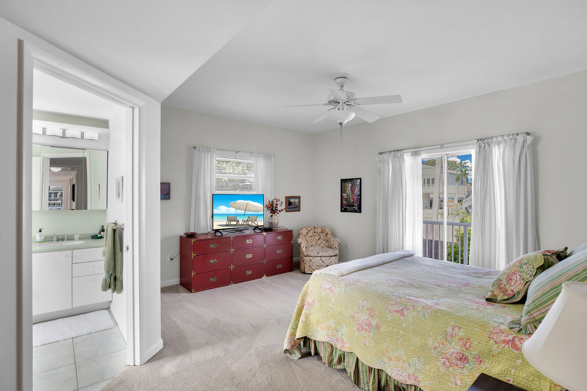 314 Loeb Avenue Key Largo, FL 33037 - Photo 20 of 28 a bedroom with a bed and a chandelier