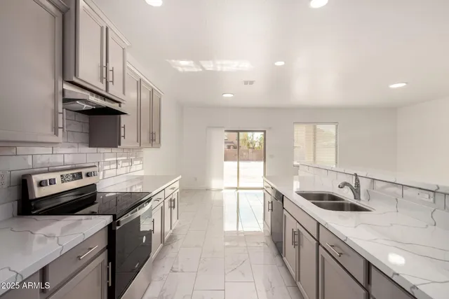 a kitchen with a sink stove and cabinets