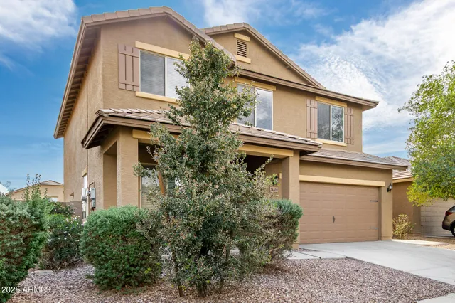 a front view of a house with plants
