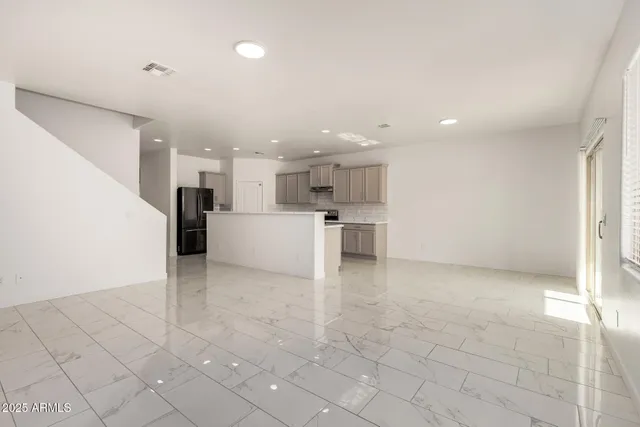 a view of a kitchen with furniture and an empty room