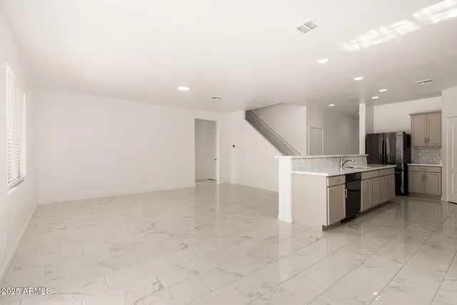a view of kitchen with stainless steel appliances a refrigerator and a stove top oven