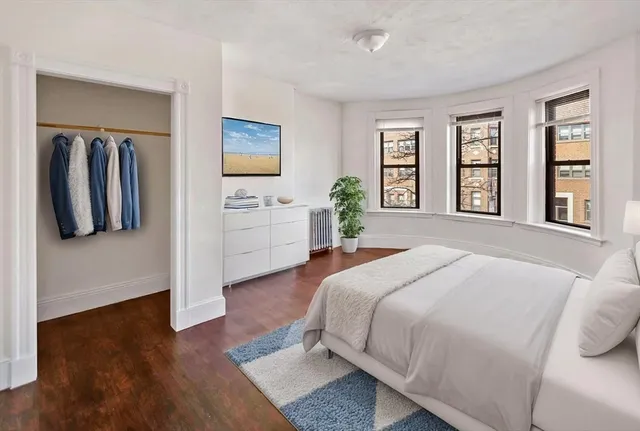 a spacious bedroom with a bed and a couch