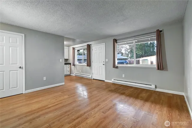 a kitchen with granite countertop white cabinets and stainless steel appliances