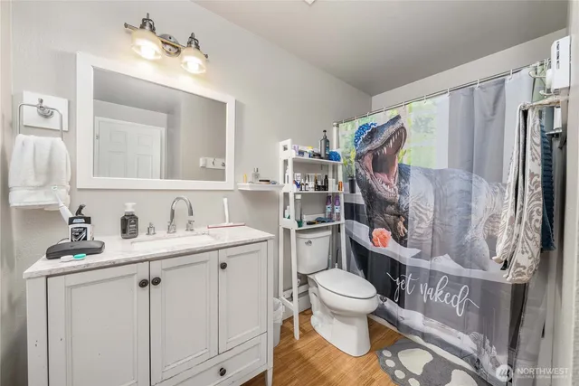a white kitchen with sink and white appliances
