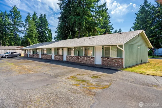 a front view of a house with a yard garage and outdoor seating