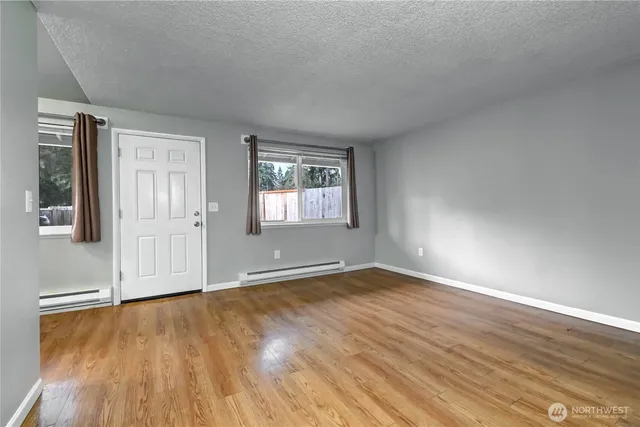 a living room with furniture and kitchen view