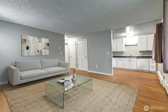 a view of large kitchen with granite countertop cabinets and refrigerator