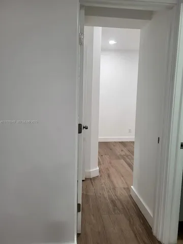 a view of a room with wooden floor