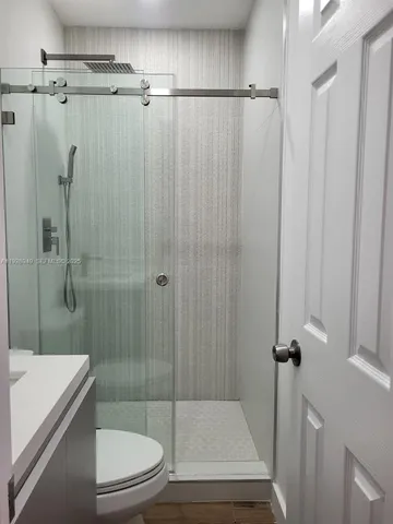 a bathroom with a shower and a toilet