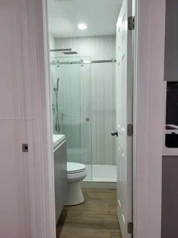 a bathroom with a shower toilet and sink