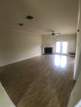 a view of empty room with a fireplace