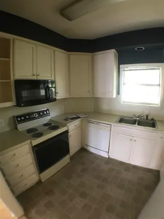 a kitchen with a refrigerator and a sink