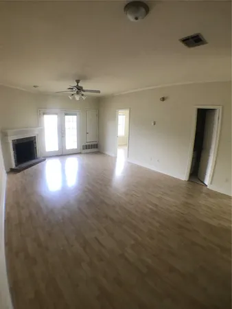 an empty room with fan and ceiling fan