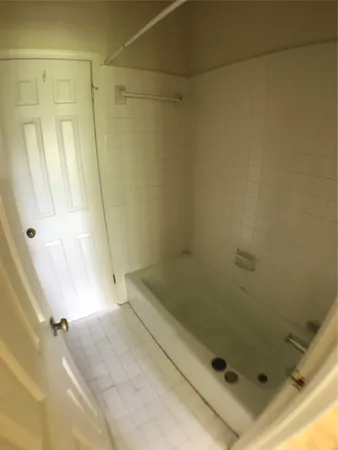 a bathroom with a bathtub and shower