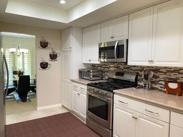 a kitchen with cabinets appliances and a wooden floor