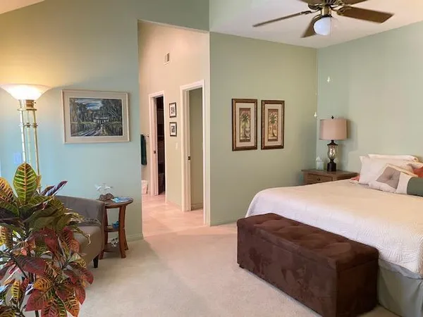 a bedroom with a bed and chair