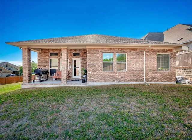 a view of a house with backyard porch and outdoor seating
