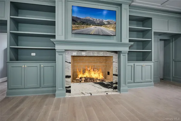a view of a livingroom with a fireplace and cabinet