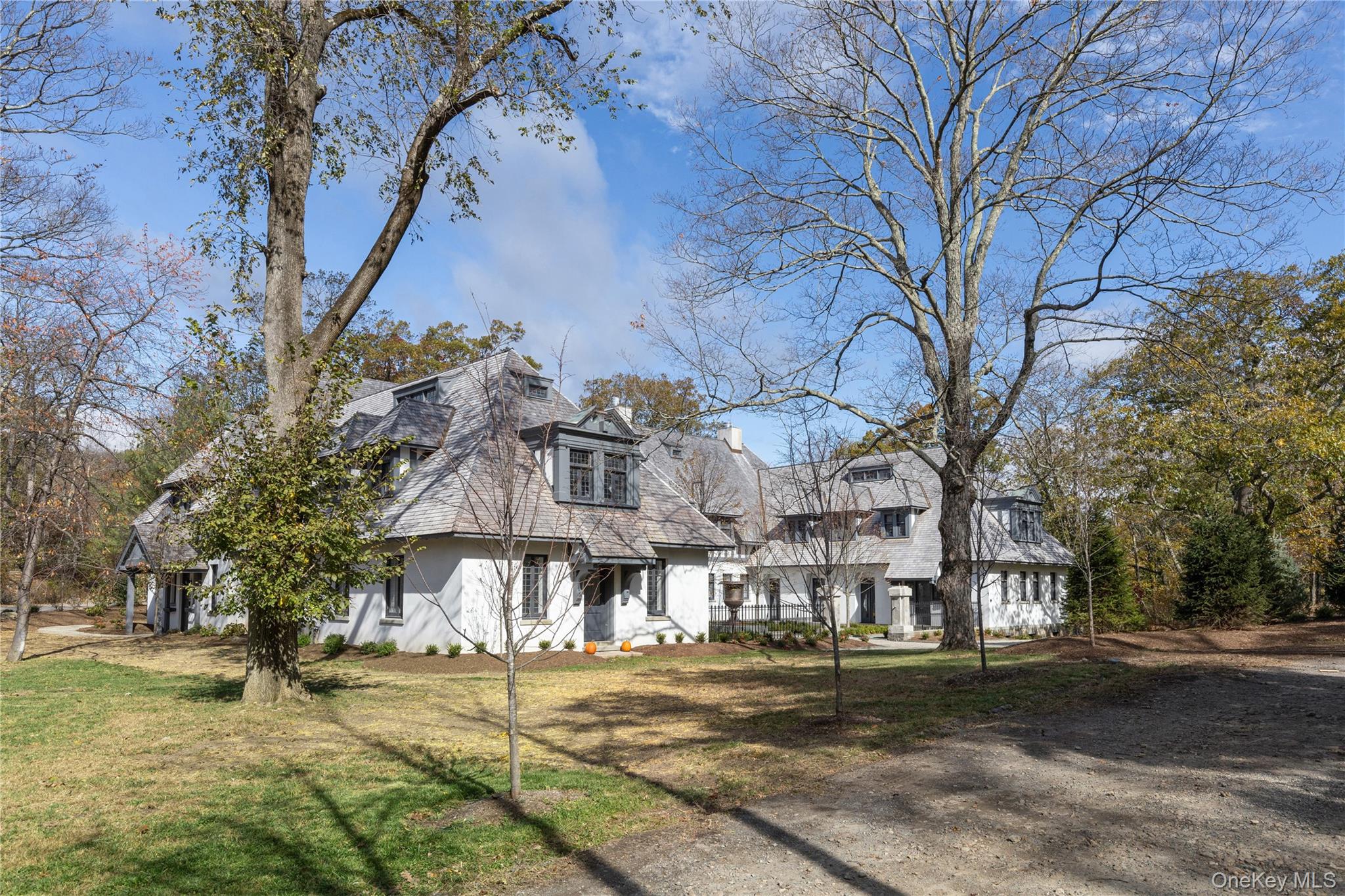 76 Summit Road Tuxedo Park, NY 10987 - Photo 2 of 37 a view of a big building with trees in the background
