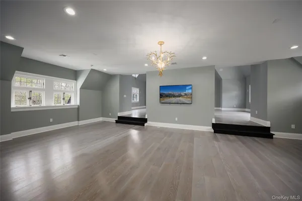 a view of an empty room with a window and fireplace
