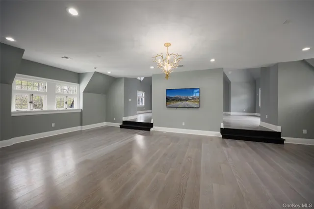 a view of an empty room with a window and fireplace