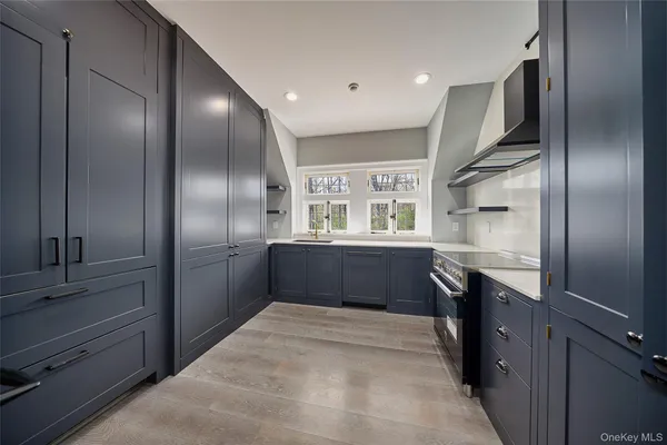 a kitchen with granite countertop stainless steel appliances cabinets and a sink