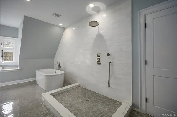 a bathroom with a granite countertop sink a toilet and shower