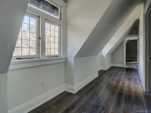 a living room with a bed furniture and a window