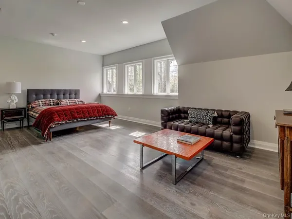 a bedroom with a bed a table and window