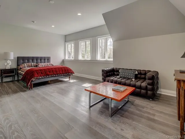 a bedroom with a bed a table and window