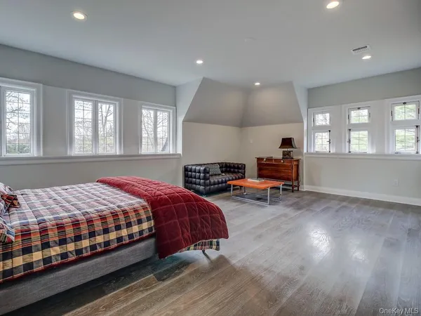 a spacious bedroom with a bed and a couch