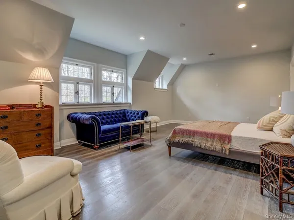 a spacious bedroom with a bed and a chandelier