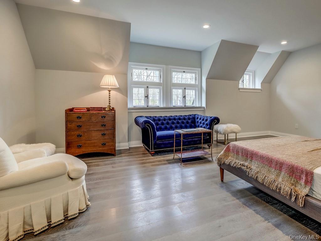 76 Summit Road Tuxedo Park, NY 10987 - Photo 36 of 37 a spacious bedroom with a bed and a chandelier