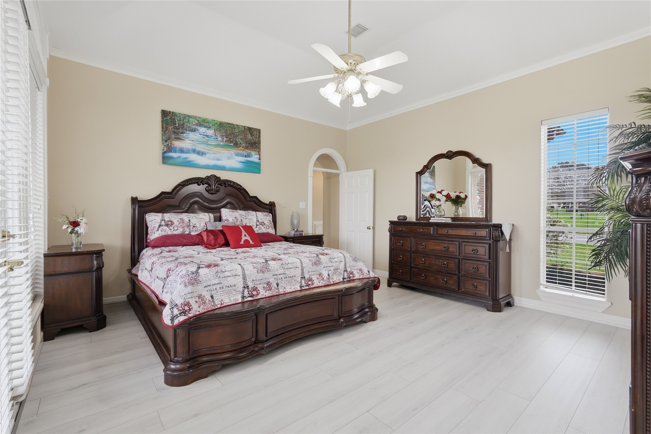 55 Monterrey Road East Montgomery, TX 77356 - Photo 22 of 50 This spacious bedroom features large windows with plenty of natural light, and a ceiling fan. The neutral walls and light flooring create a bright, inviting atmosphere.
