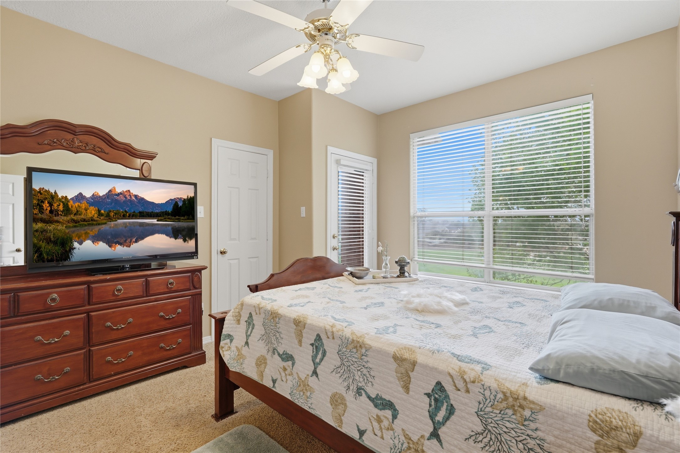 55 Monterrey Road East Montgomery, TX 77356 - Photo 32 of 50 This cozy bedroom features neutral walls, a large window allowing natural light, and a ceiling fan for comfort.