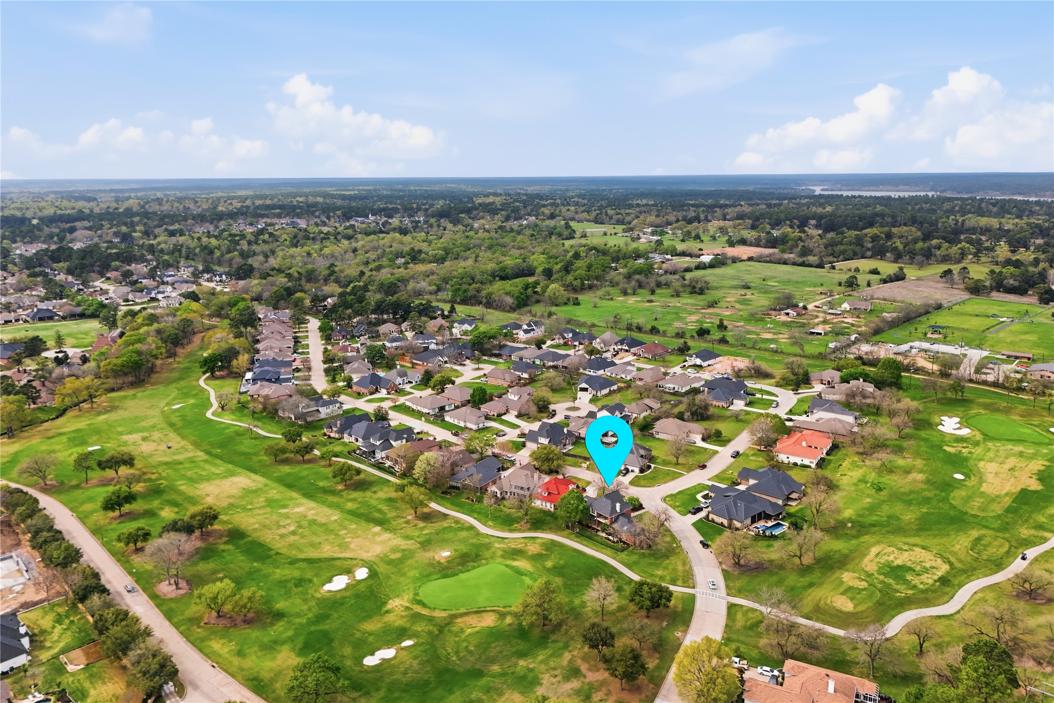 55 Monterrey Road East Montgomery, TX 77356 - Photo 46 of 50 Aerial view of a suburban neighborhood featuring spacious homes surrounded by lush greenery and a golf course. The location offers scenic views and a tranquil environment, ideal for family living.