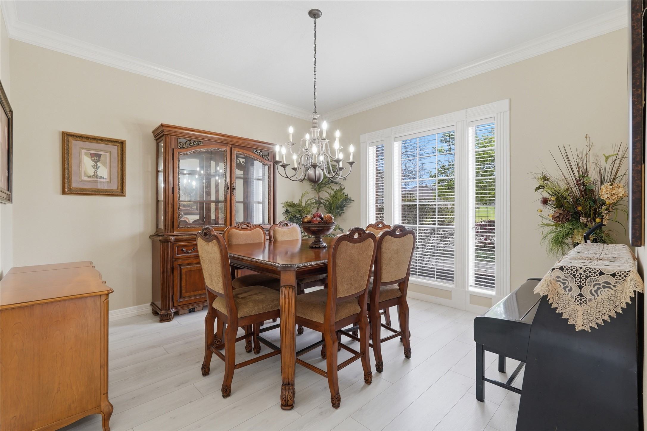 55 Monterrey Road East Montgomery, TX 77356 - Photo 8 of 50 This bright dining room features elegant chandalier and large windows with scenic views, creating a warm and inviting atmosphere.
