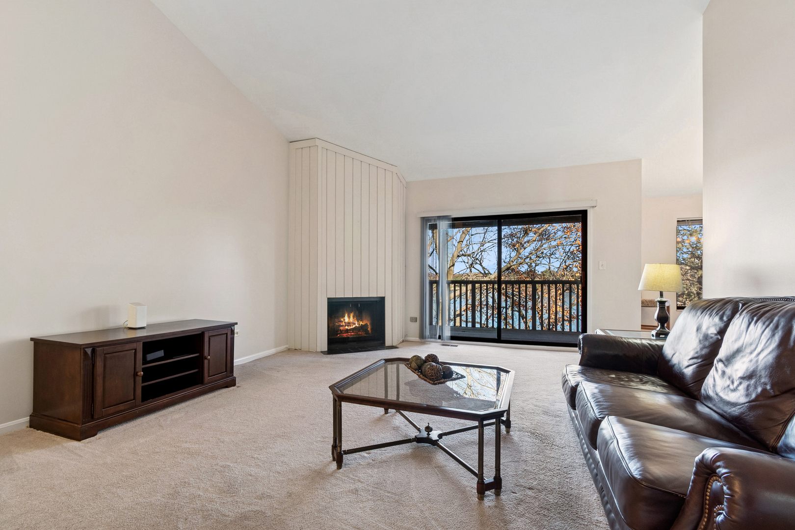 33 Shoreline Road, Unit B Lake Barrington, IL 60010 - Photo 17 of 49 a living room with furniture a fireplace and a window