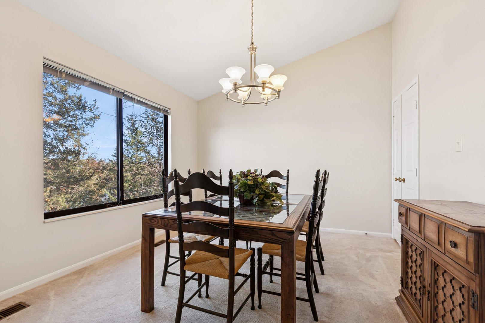 33 Shoreline Road, Unit B Lake Barrington, IL 60010 - Photo 8 of 49 a view of a dining room with furniture a chandelier and wooden floor