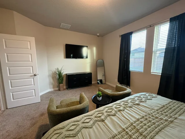 a bedroom with bed and window