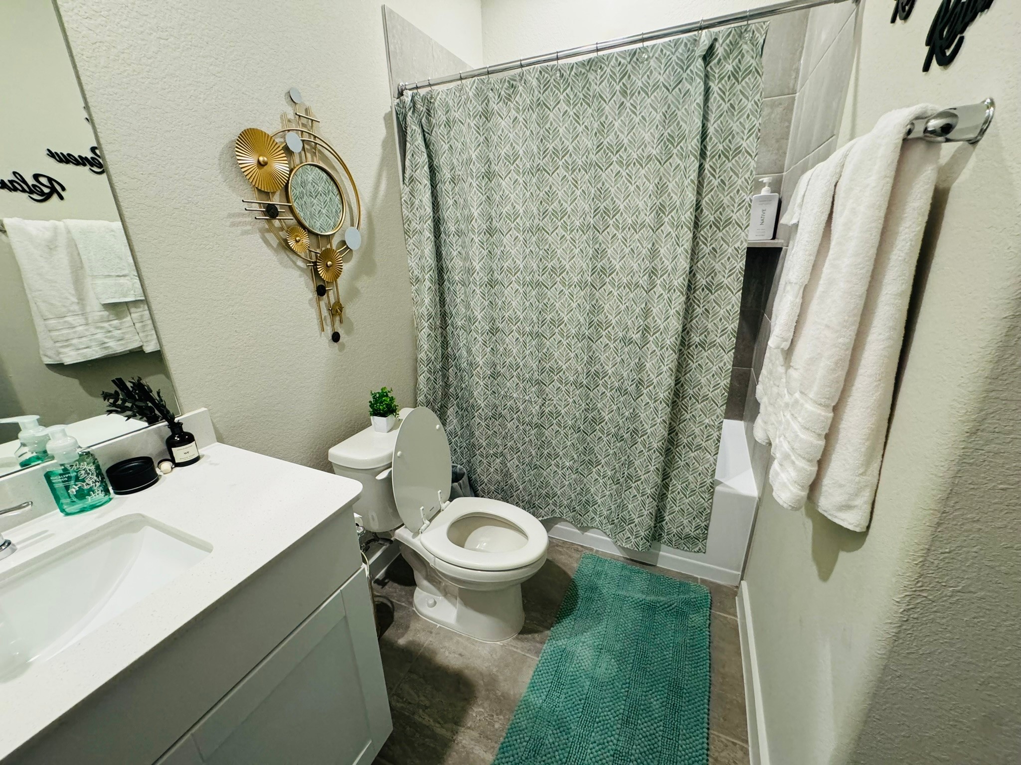 5608 Madden Lane Houston, TX 77048 - Photo 16 of 29 a bathroom with a sink a toilet and shower curtain