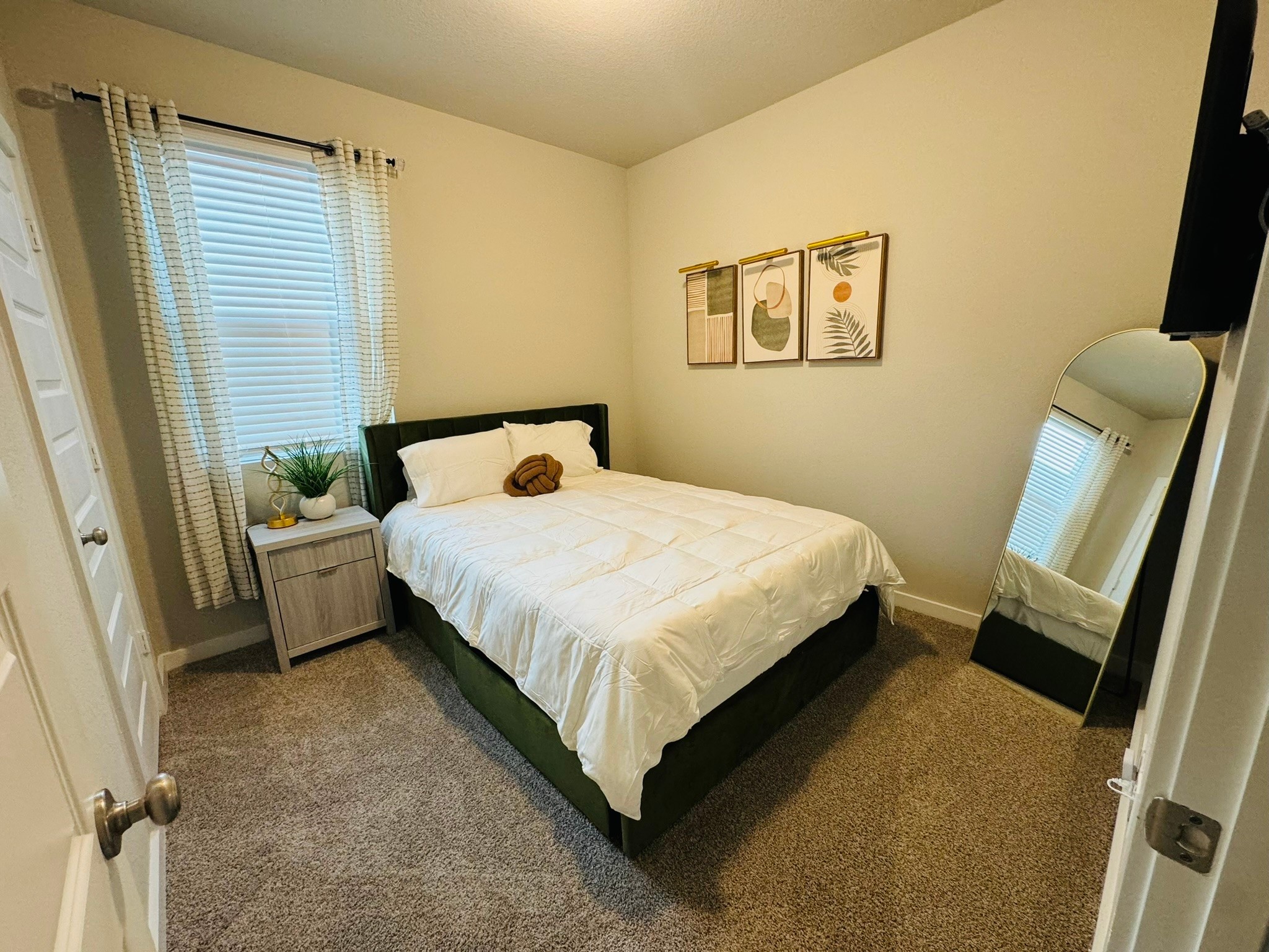 5608 Madden Lane Houston, TX 77048 - Photo 18 of 29 a bedroom with a bed a couch and a window