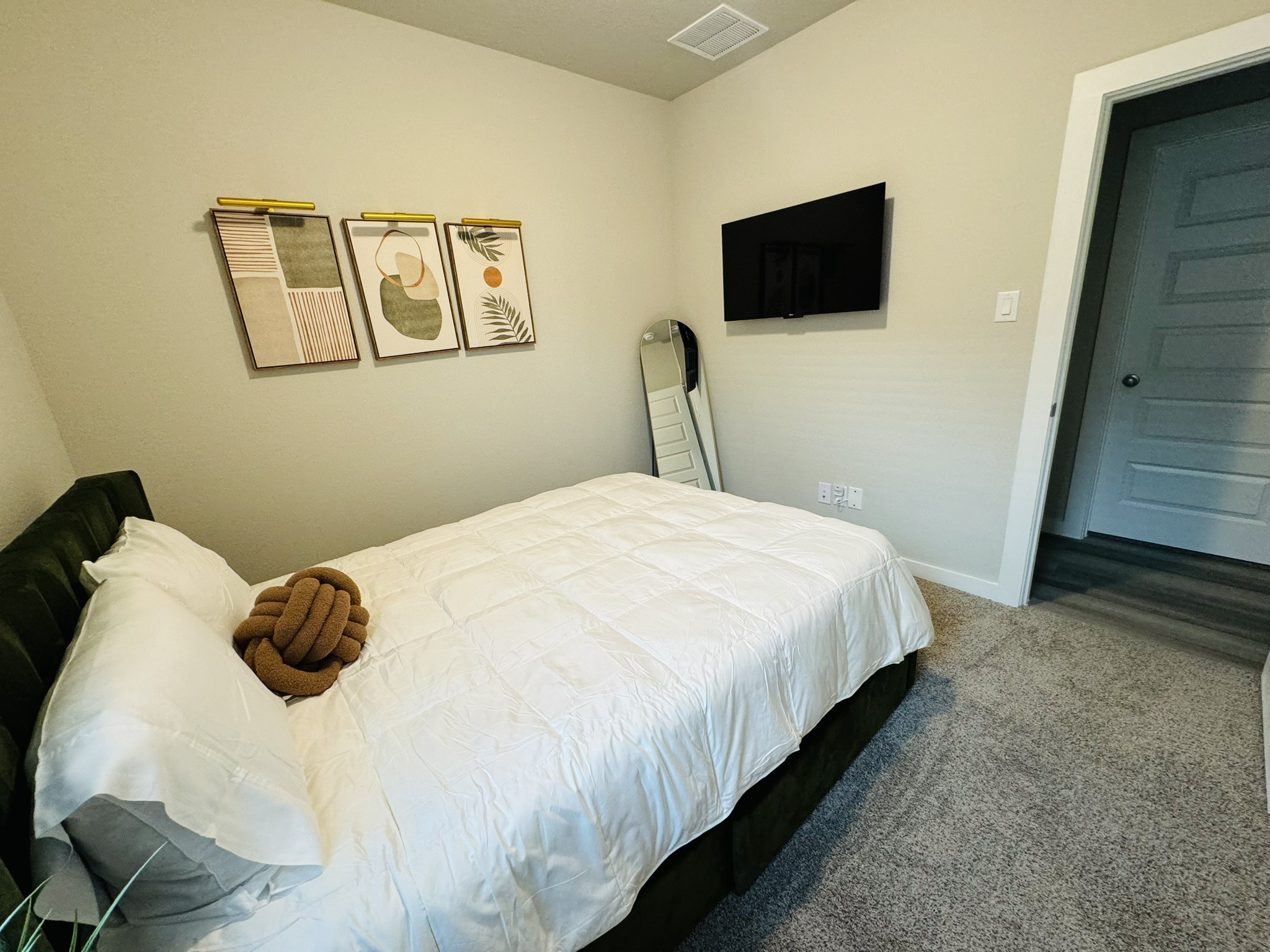 5608 Madden Lane Houston, TX 77048 - Photo 19 of 29 a bedroom with a bed and a flat screen tv