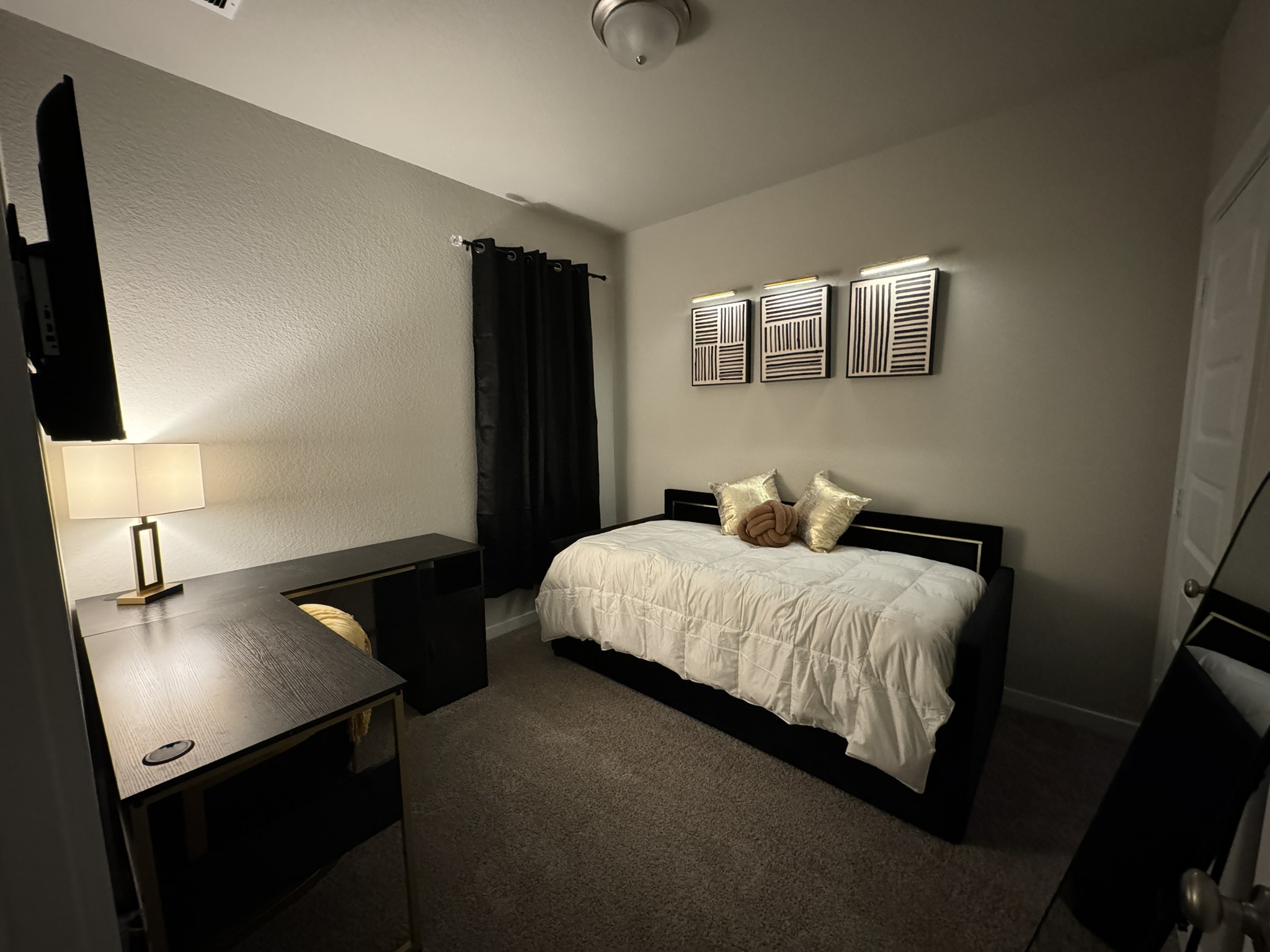 5608 Madden Lane Houston, TX 77048 - Photo 27 of 29 a bedroom with a bed and a flat tv screen on a dresser
